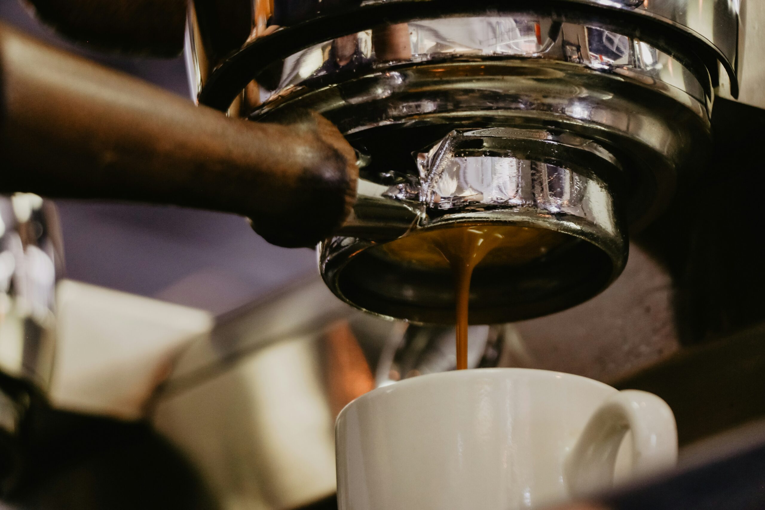 View of a coffee machine with freshly brewed coffee dripping down