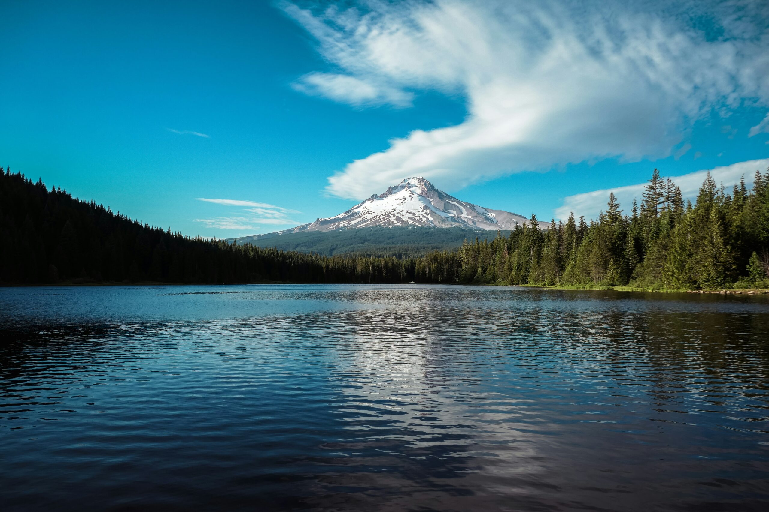 White mountain peak photographed from a lake.