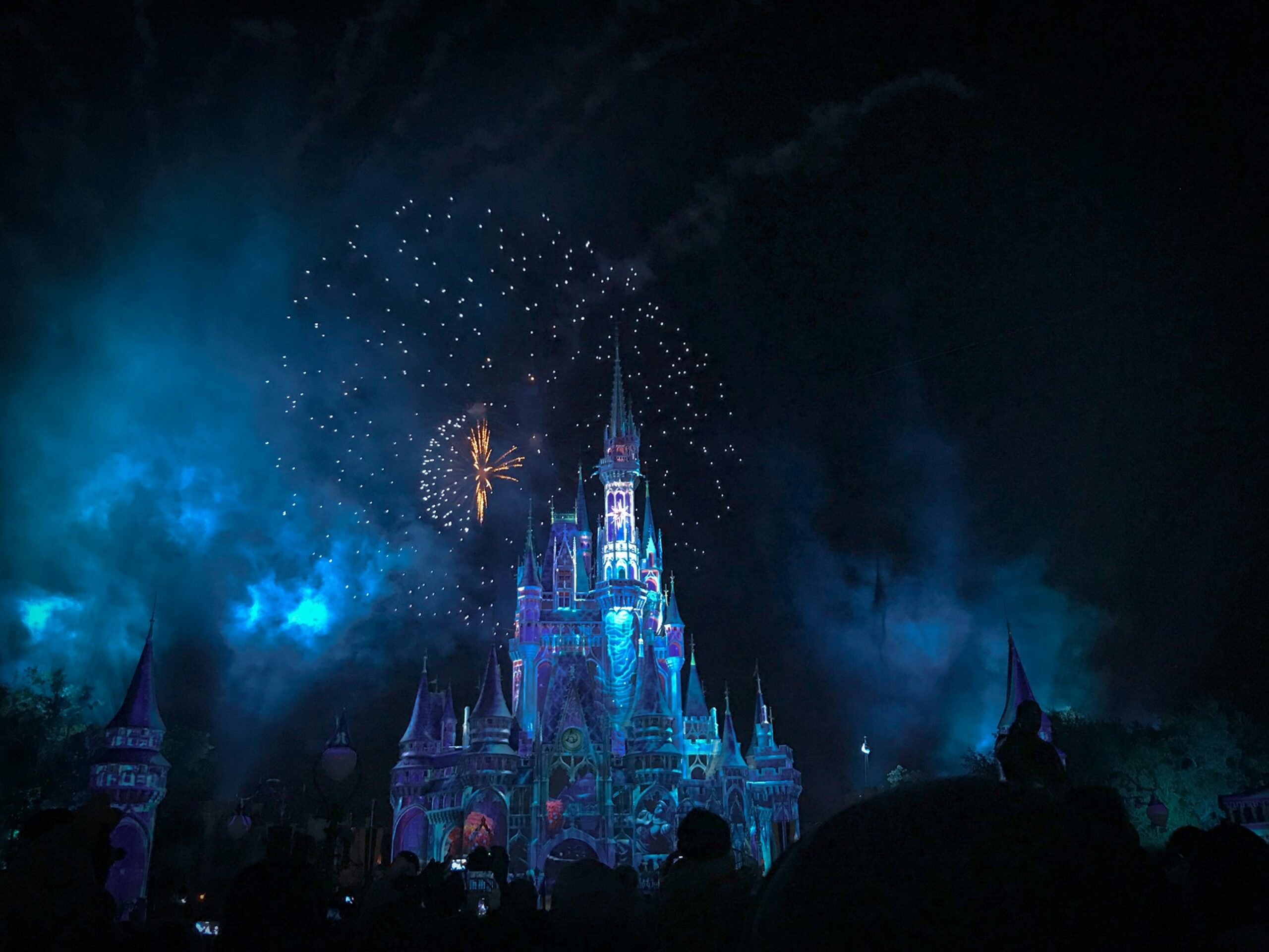 View of the castle of Disneyland at night with blue lights