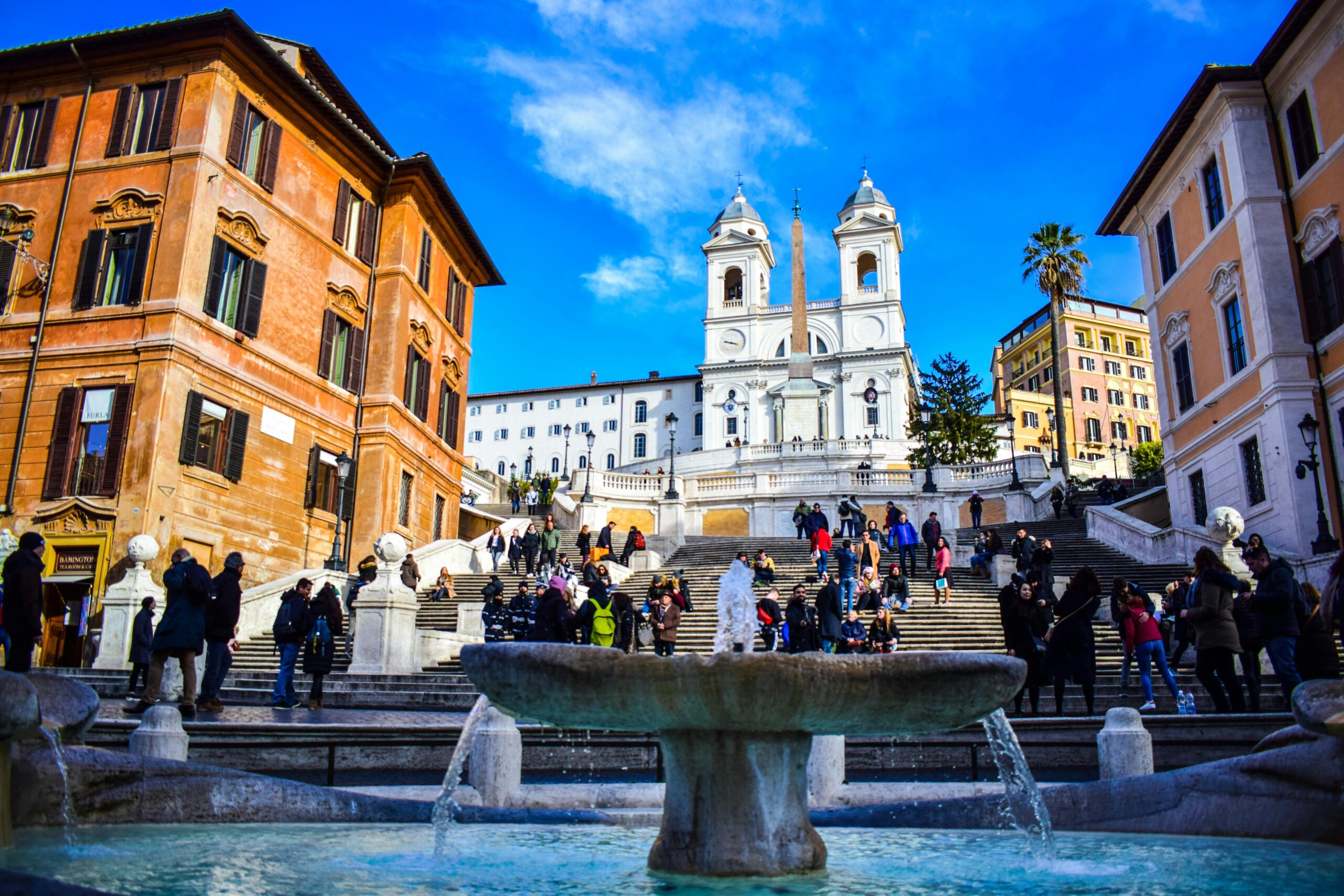 View of the Spanish Steps in Central Rome with tourists climbing up and down